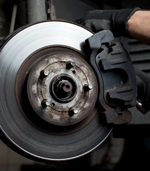 mechanic replacing rotors on a car